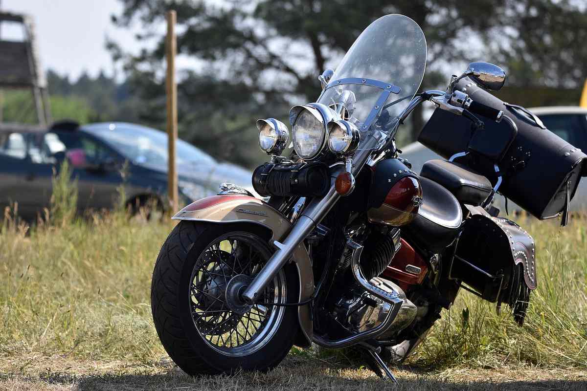 Motocyclette équipée de sacoches et pare-brise, posée sur herbe Motocyclette équipée de sacoches et pare-brise, posée sur herbe